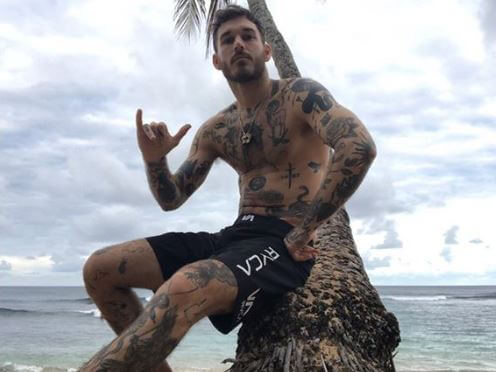 David Alexander Flinn flaunting his toned abs and tattoos.